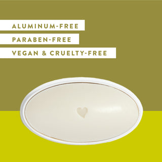 Inside of Native Desert Grass & Sandalwood deodorant laid flat on a green background