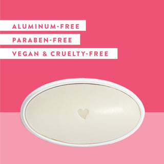 Inside of Native Wild Cherry & Yuzu deodorant laid flat on cherry pink background